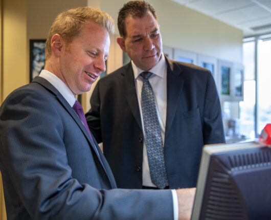 Two dentist is looking at the desktop screen