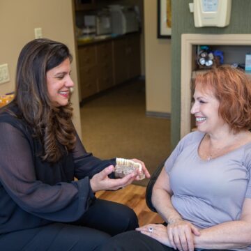 The dentist is showing the Teeth model to the Patient