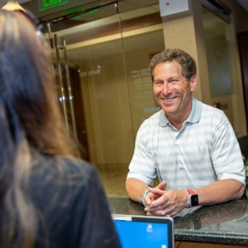 Dental Patient smiling at the reception desk