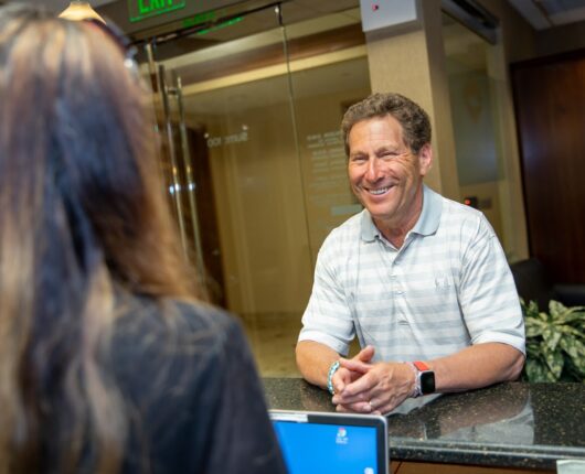 Dental Patient smiling at the reception desk